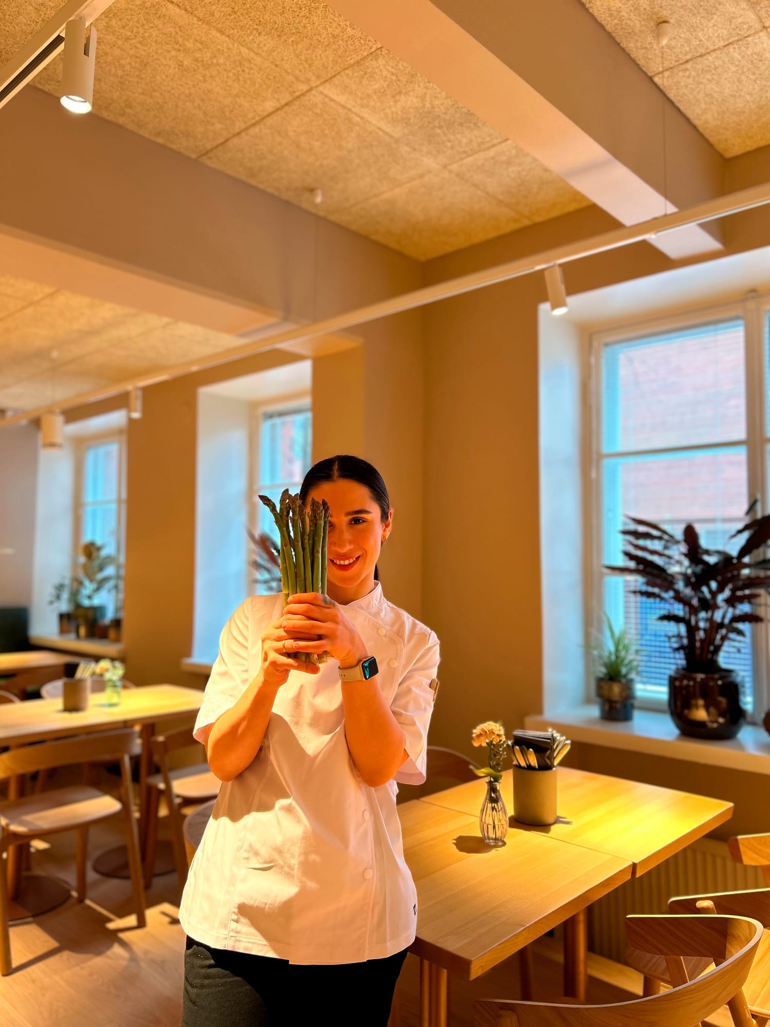 Private chef Serpil Yilmaz-Rantanen holding fresh seasonal asparagus