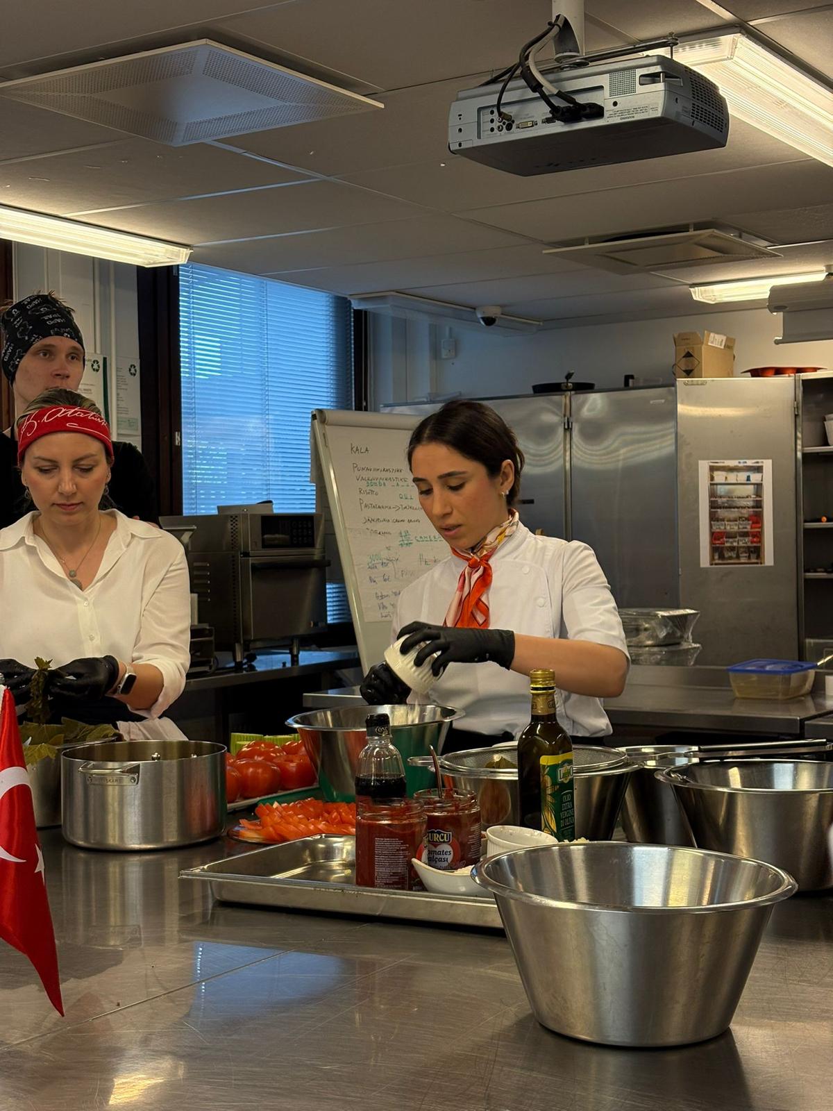 Chef Serpil Rantanen preparing ingredients in a professional teaching kitchen